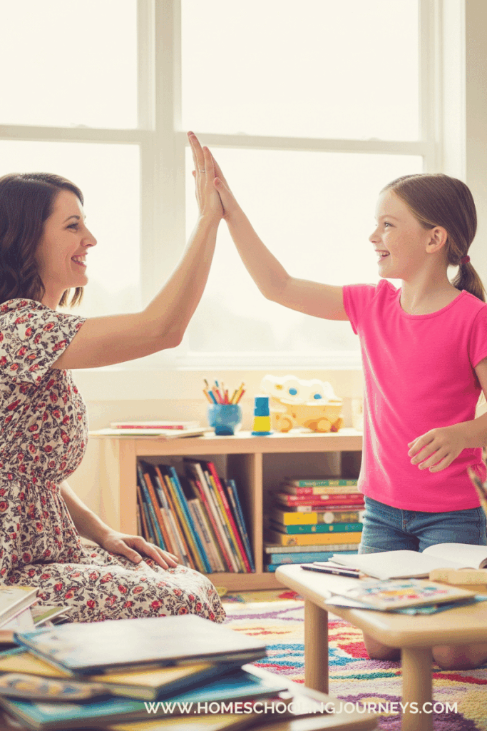 An image of a mother and child high-fiving as they celebrate homeschool wins.